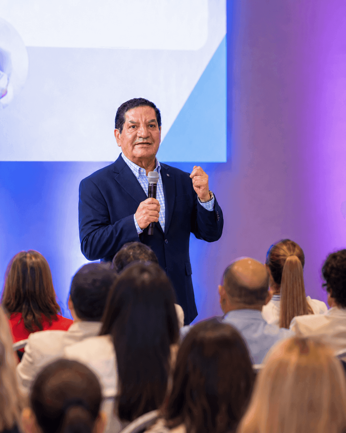 José Fernando Orellana hablando con micrófono ante el público en una charla de liderazgo